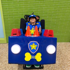 Child in a Chase from Paw Patrol costume on wheels