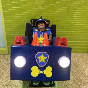 Child in a Chase from Paw Patrol costume on wheels