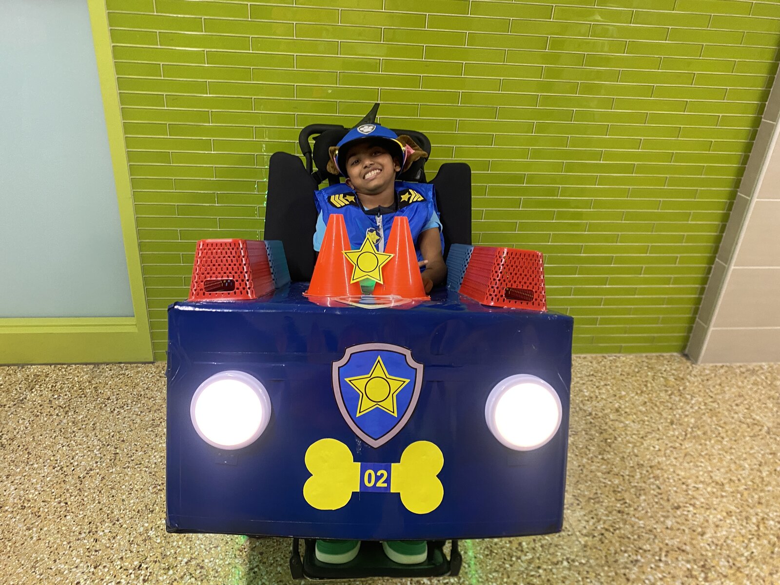 Child in a Chase from Paw Patrol costume on wheels