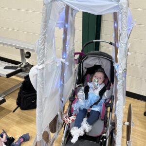 Child in a Cinderella's Carriage costume on wheels