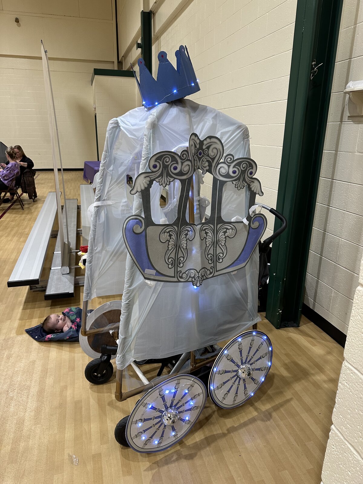 Cinderella's Carriage costume on wheels with a crown and light-up wheels