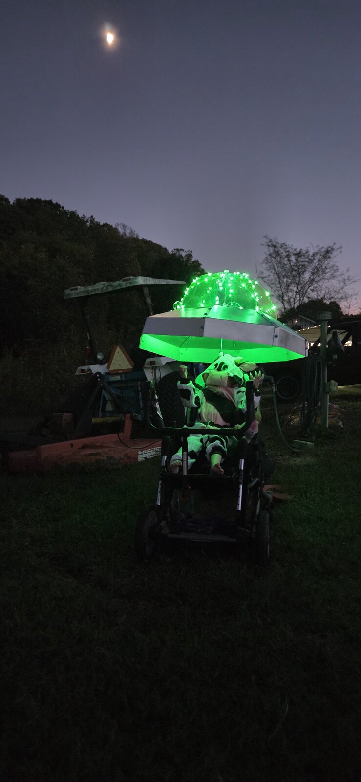 Child in a Cow Abducted by Aliens costume on wheels