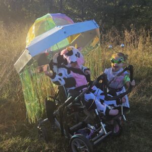 Child in a Cow Abducted by Aliens costume on wheels