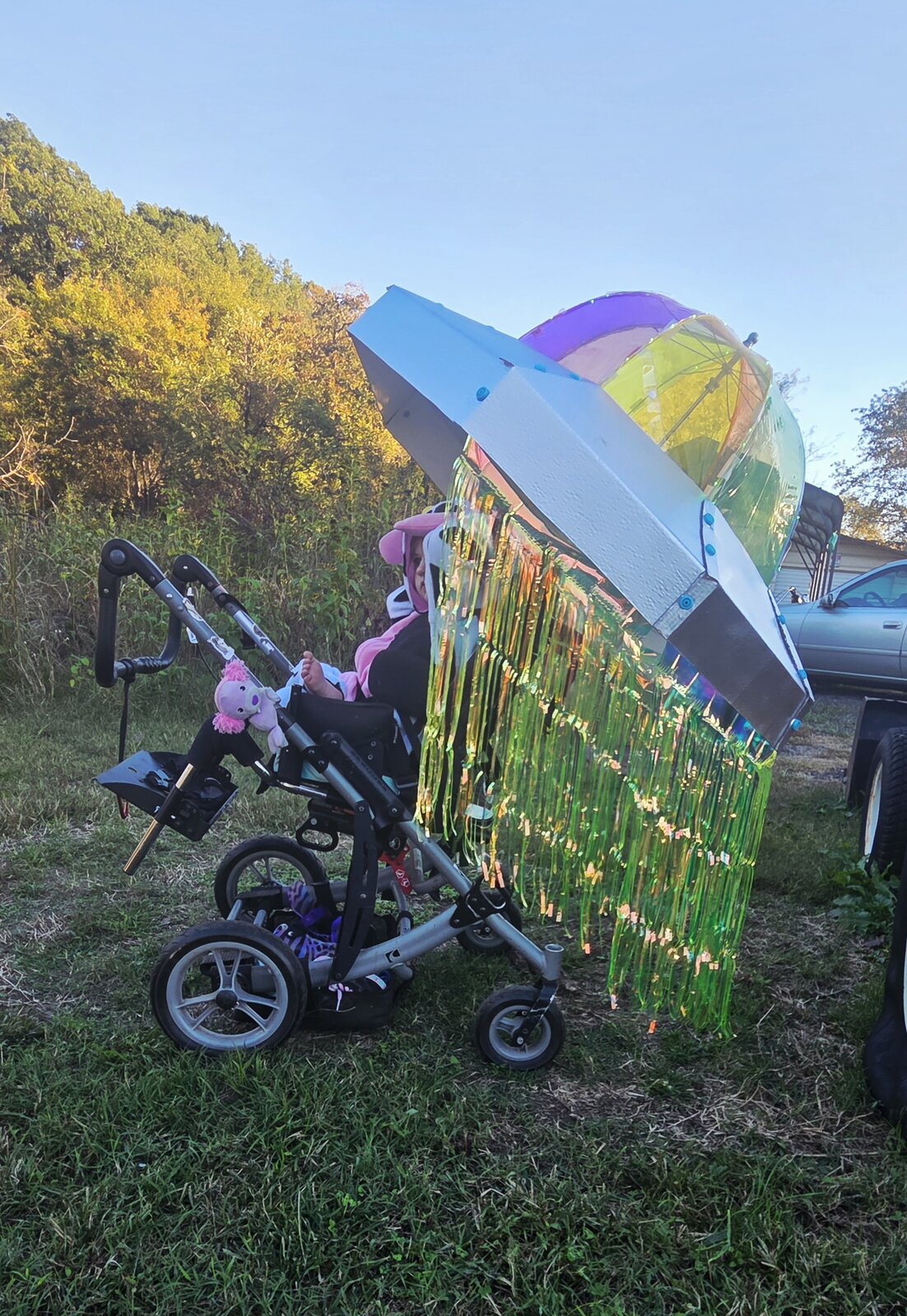 Child in a Cow Abducted by Aliens costume on wheels