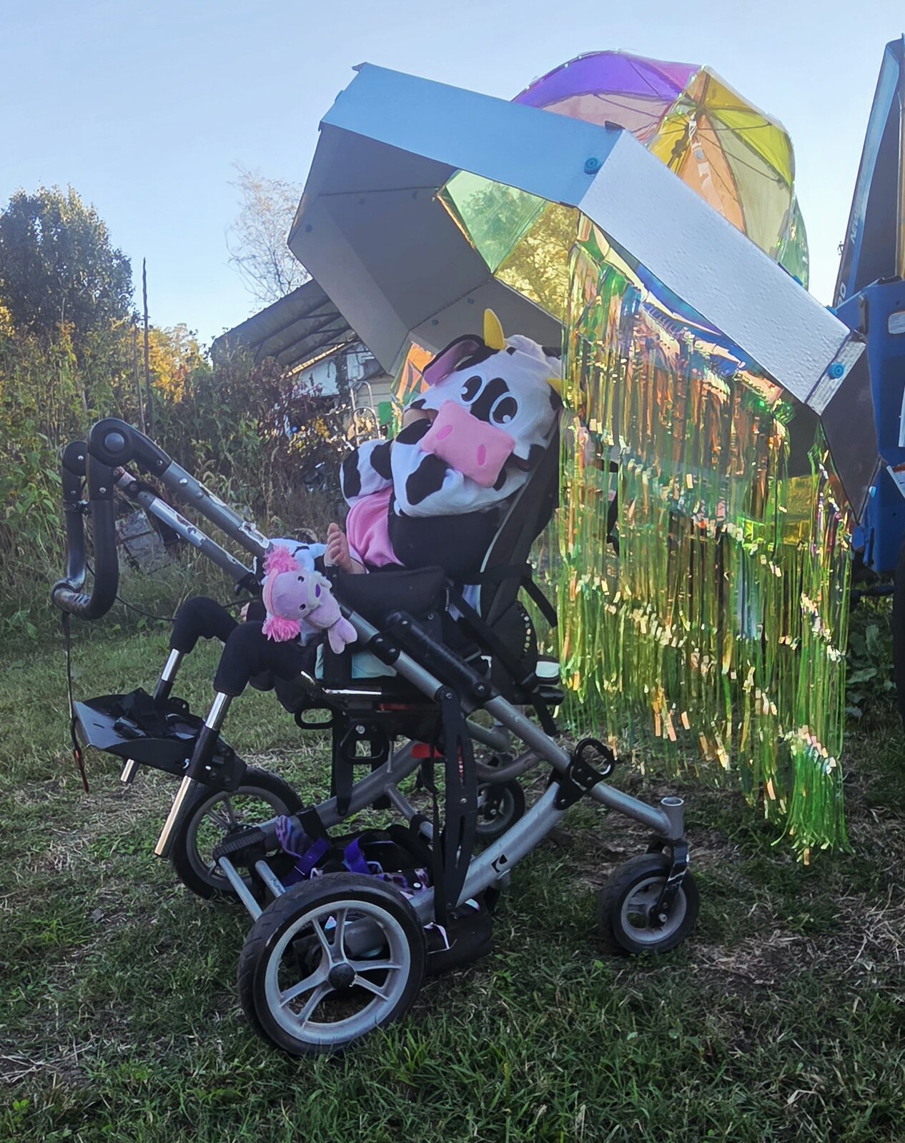 Child in a Cow Abducted by Aliens costume on wheels
