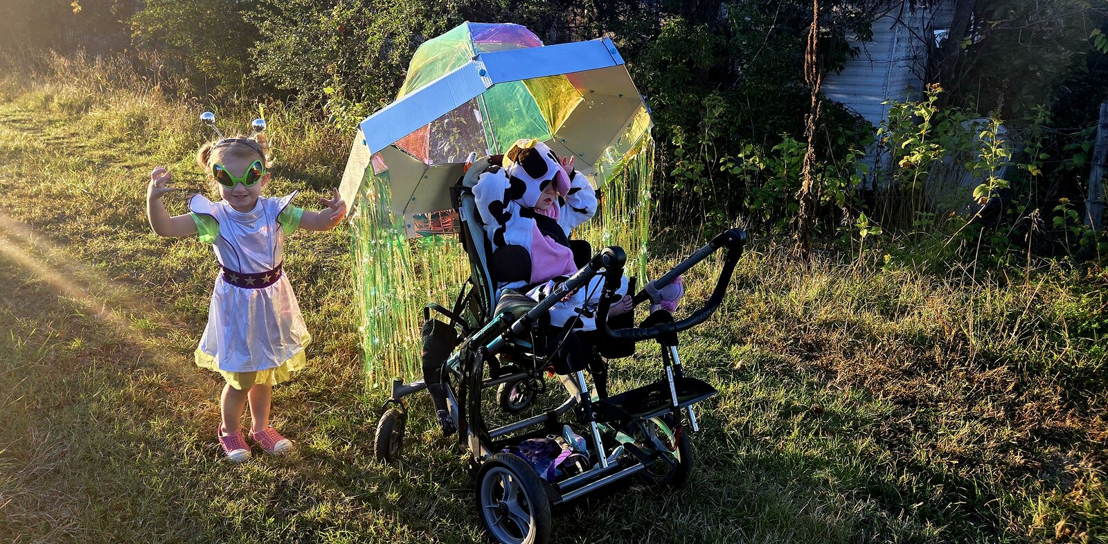 Child in a Cow Abducted by Aliens costume on wheels