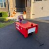Child in a Firetruck costume on wheels