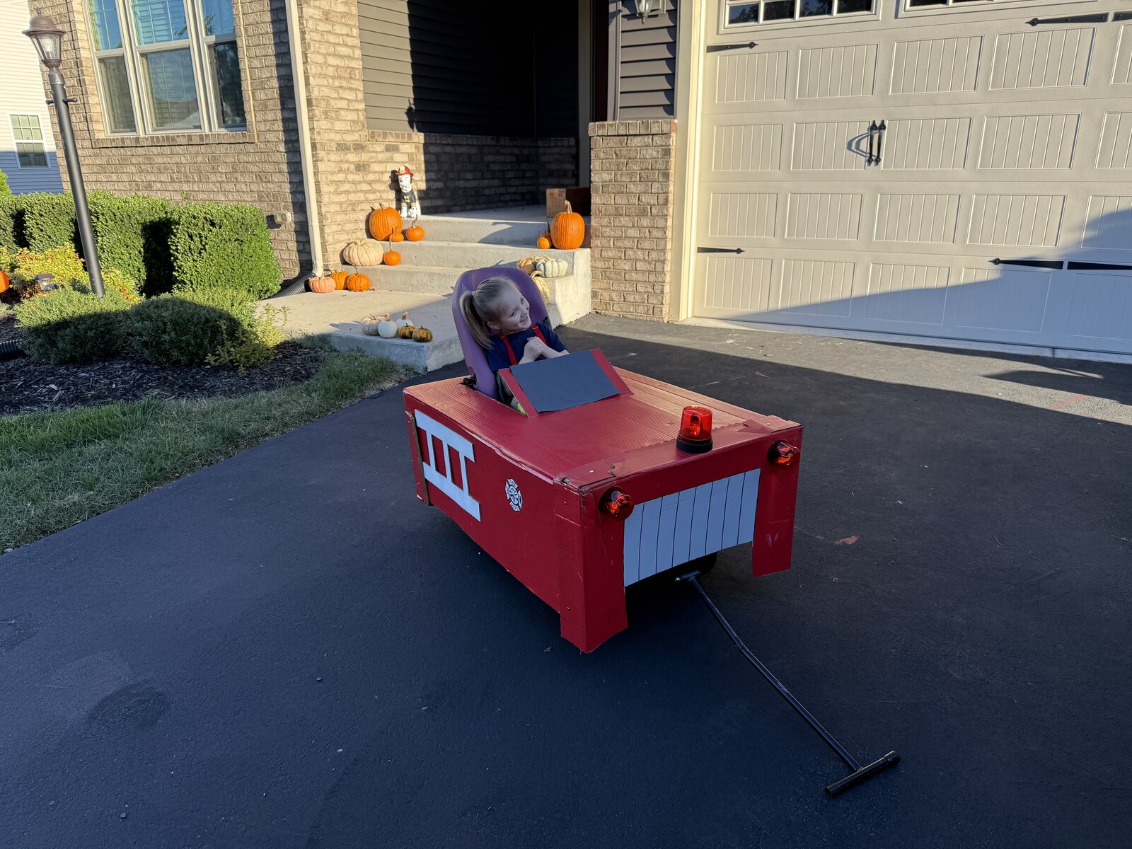 Child in a Firetruck costume on wheels