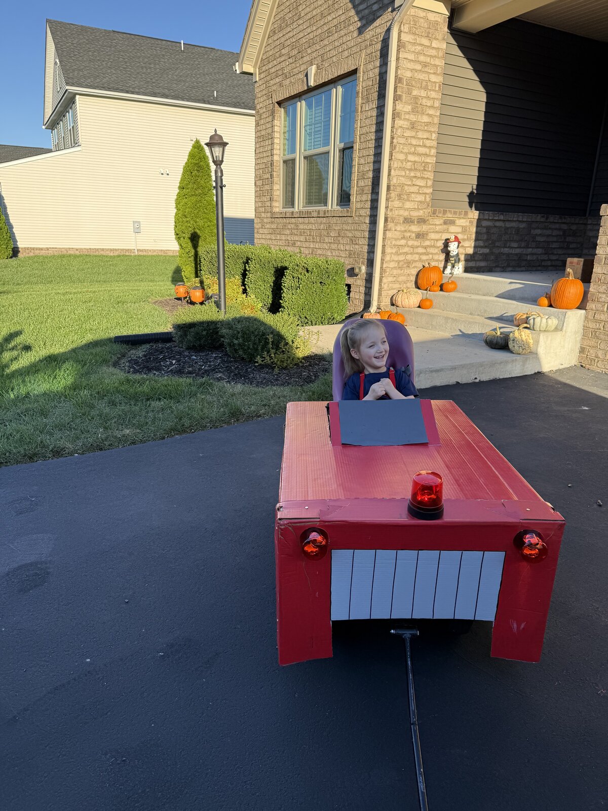 Child in a Firetruck costume on wheels