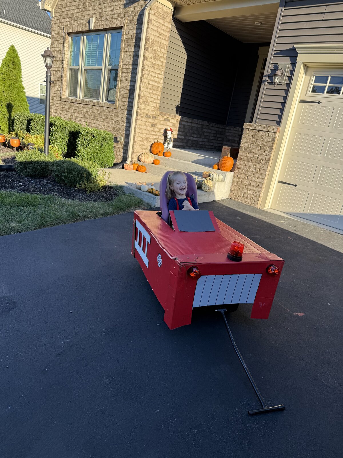 Child in a Firetruck costume on wheels