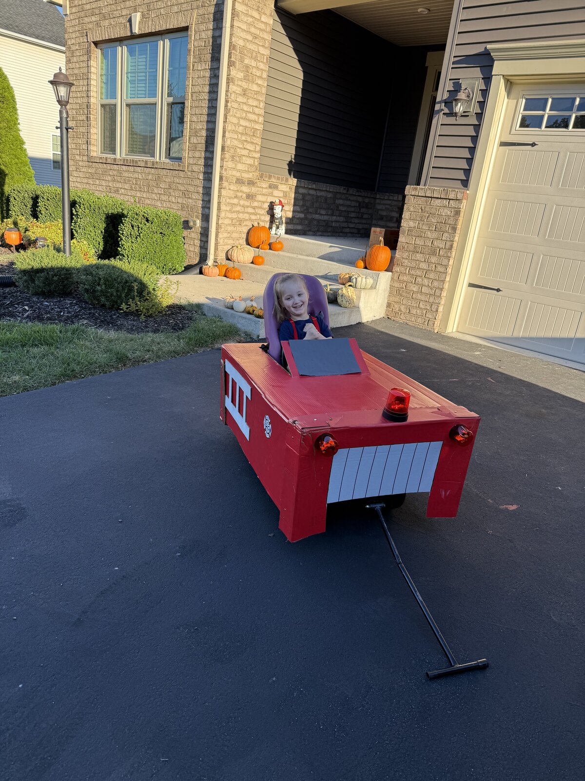 Child in a Firetruck costume on wheels