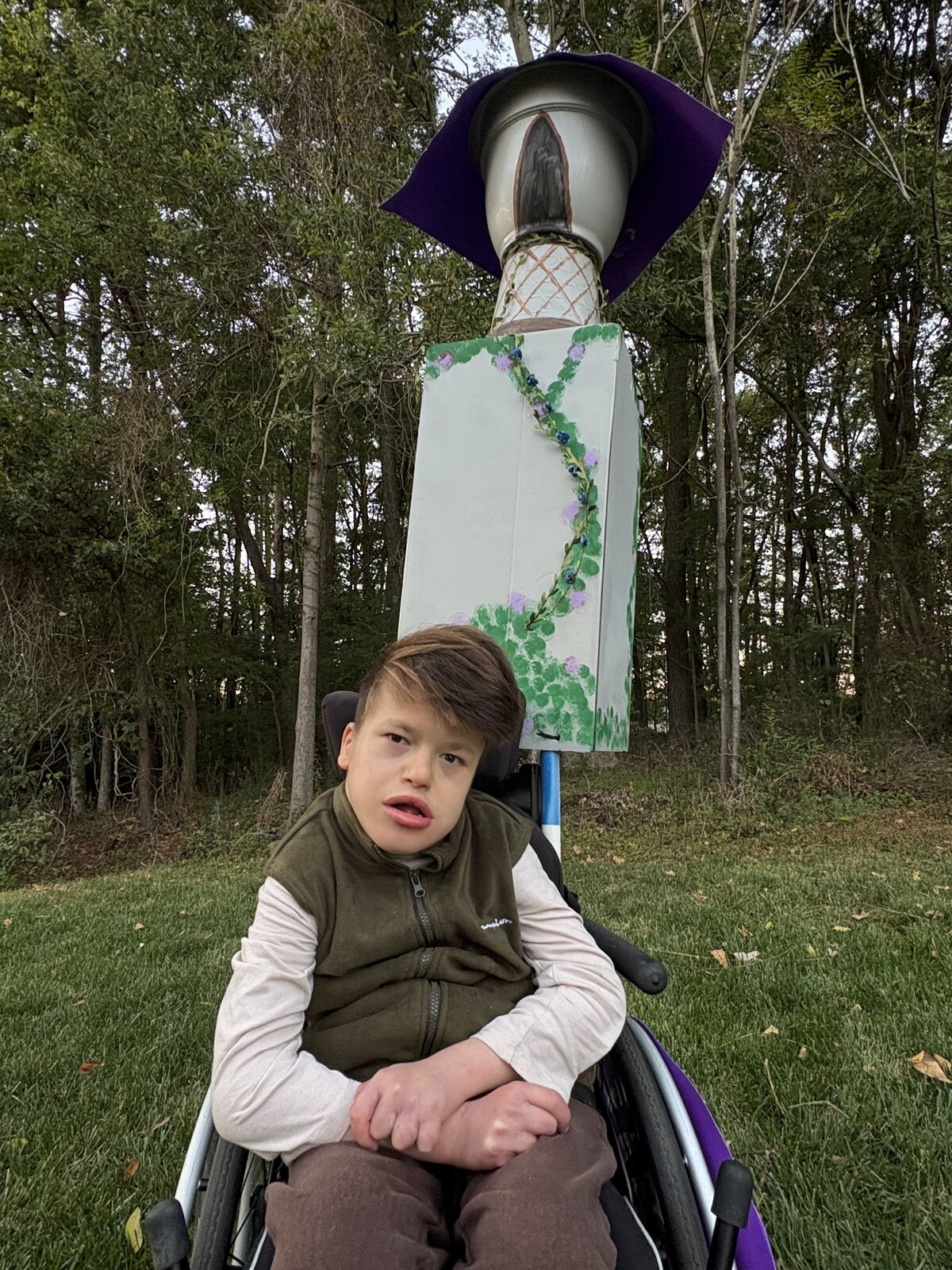 Child in a Flynn Rider with the Rapunzel Tower costume on wheels
