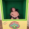 Child in a Cabbage Patch Doll costume on wheels