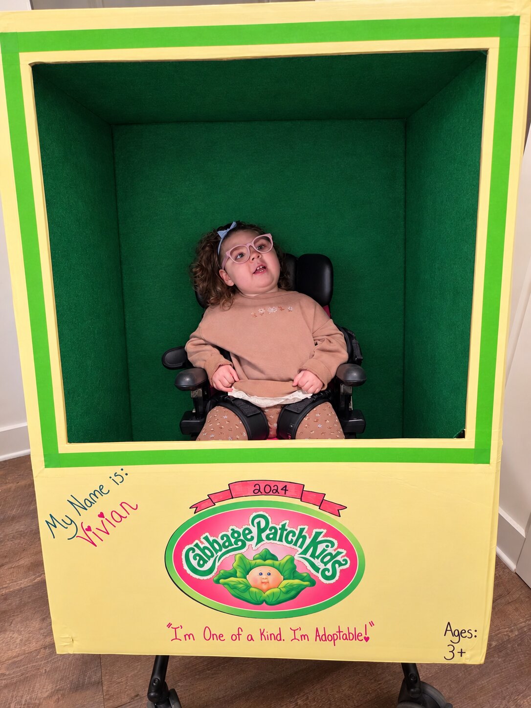 Child in a Cabbage Patch Doll costume on wheels