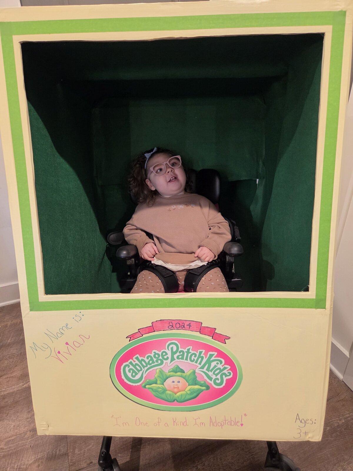Child in a Cabbage Patch Doll costume on wheels