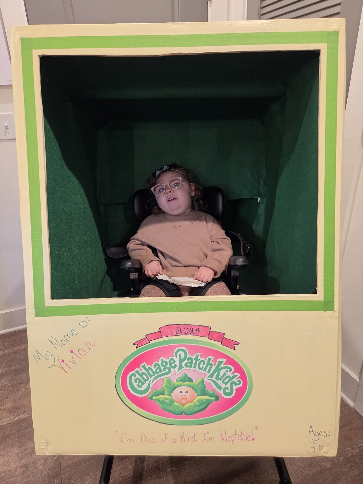 Child in a Cabbage Patch Doll costume on wheels