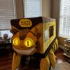 Child in a Catbus from My Neighbor Totoro costume on wheels