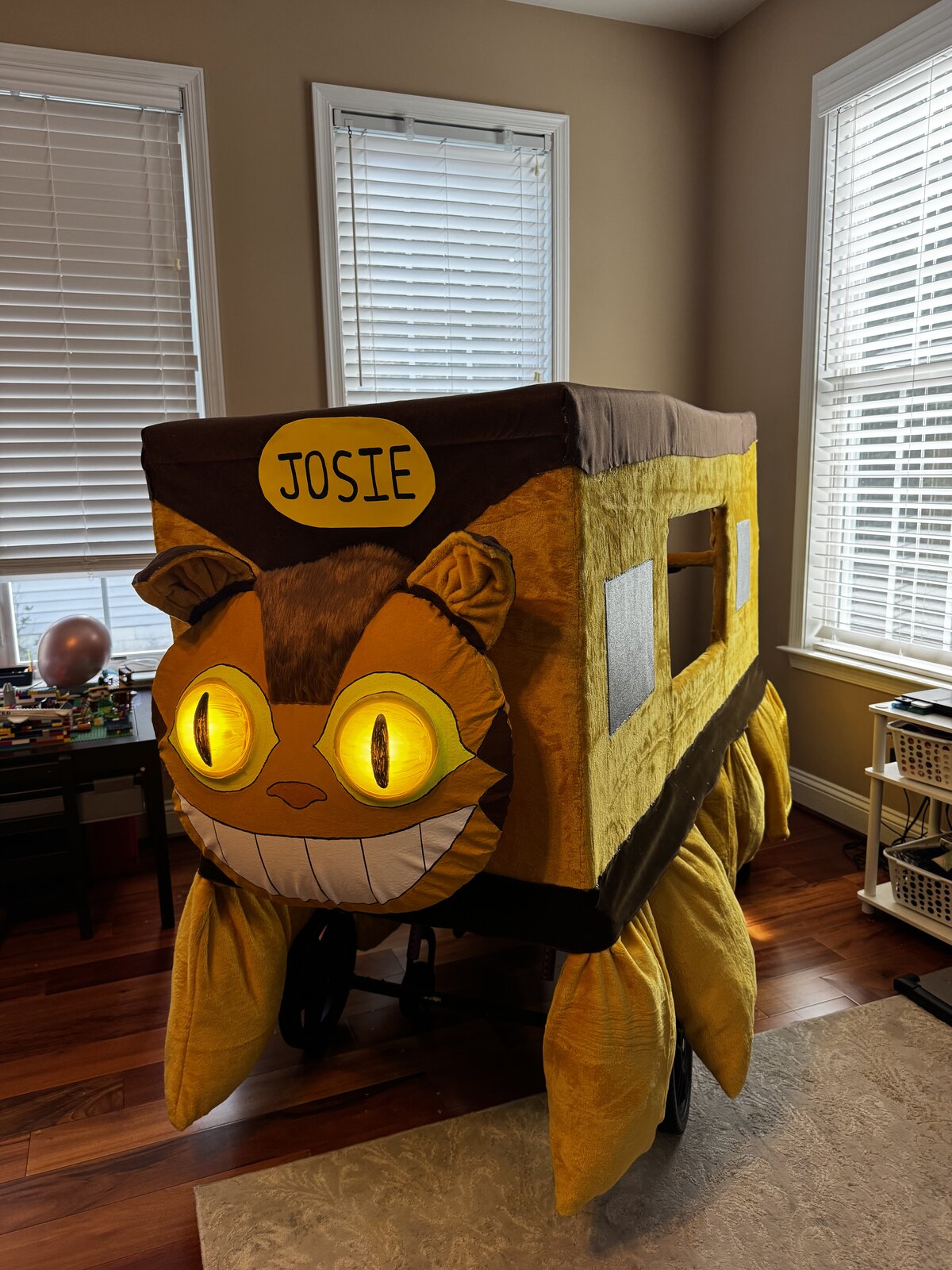 Child in a Catbus from My Neighbor Totoro costume on wheels