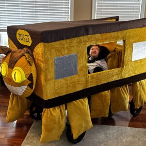 Child in a Catbus from My Neighbor Totoro costume on wheels