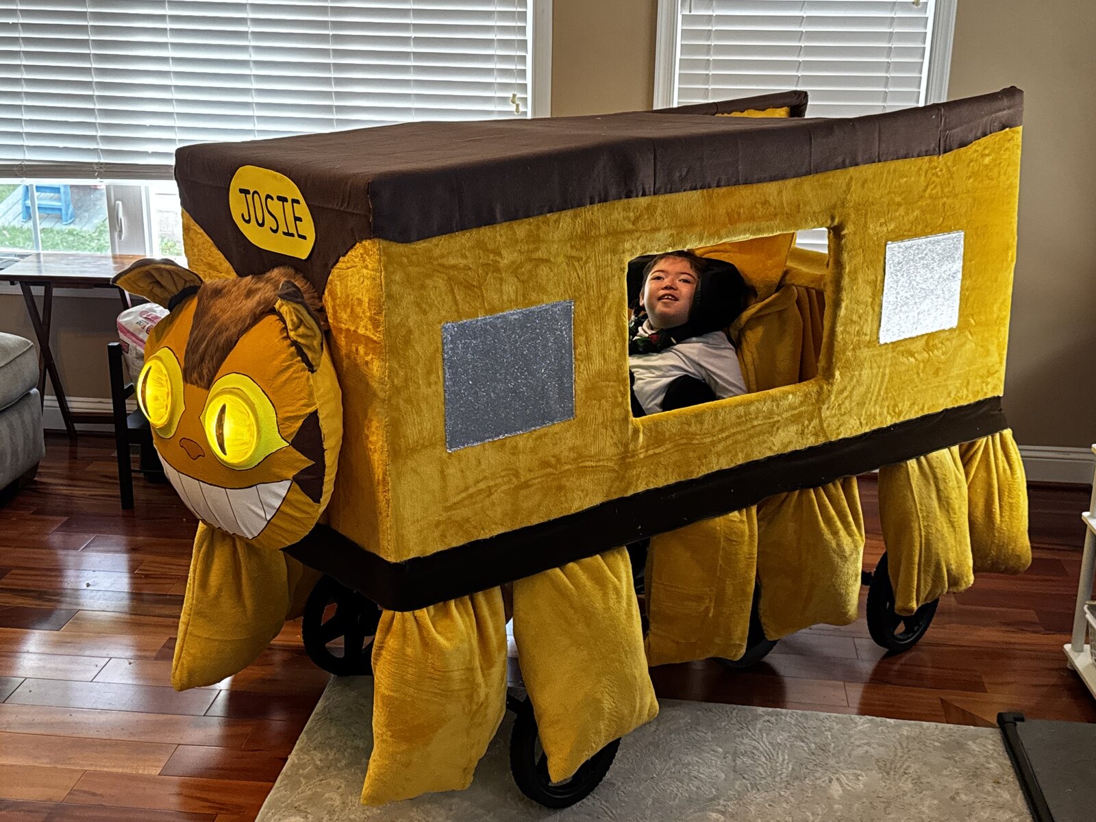 Child in a Catbus from My Neighbor Totoro costume on wheels
