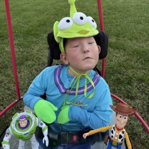 Child in a Claw Machine costume on wheels