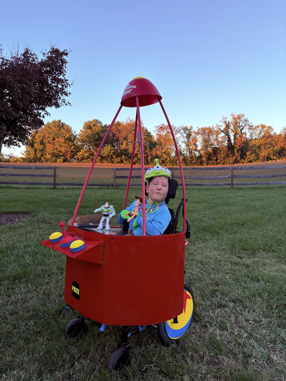 Child in a Claw Machine costume on wheels