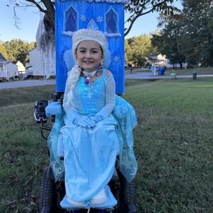 Child in an Elsa costume on wheels