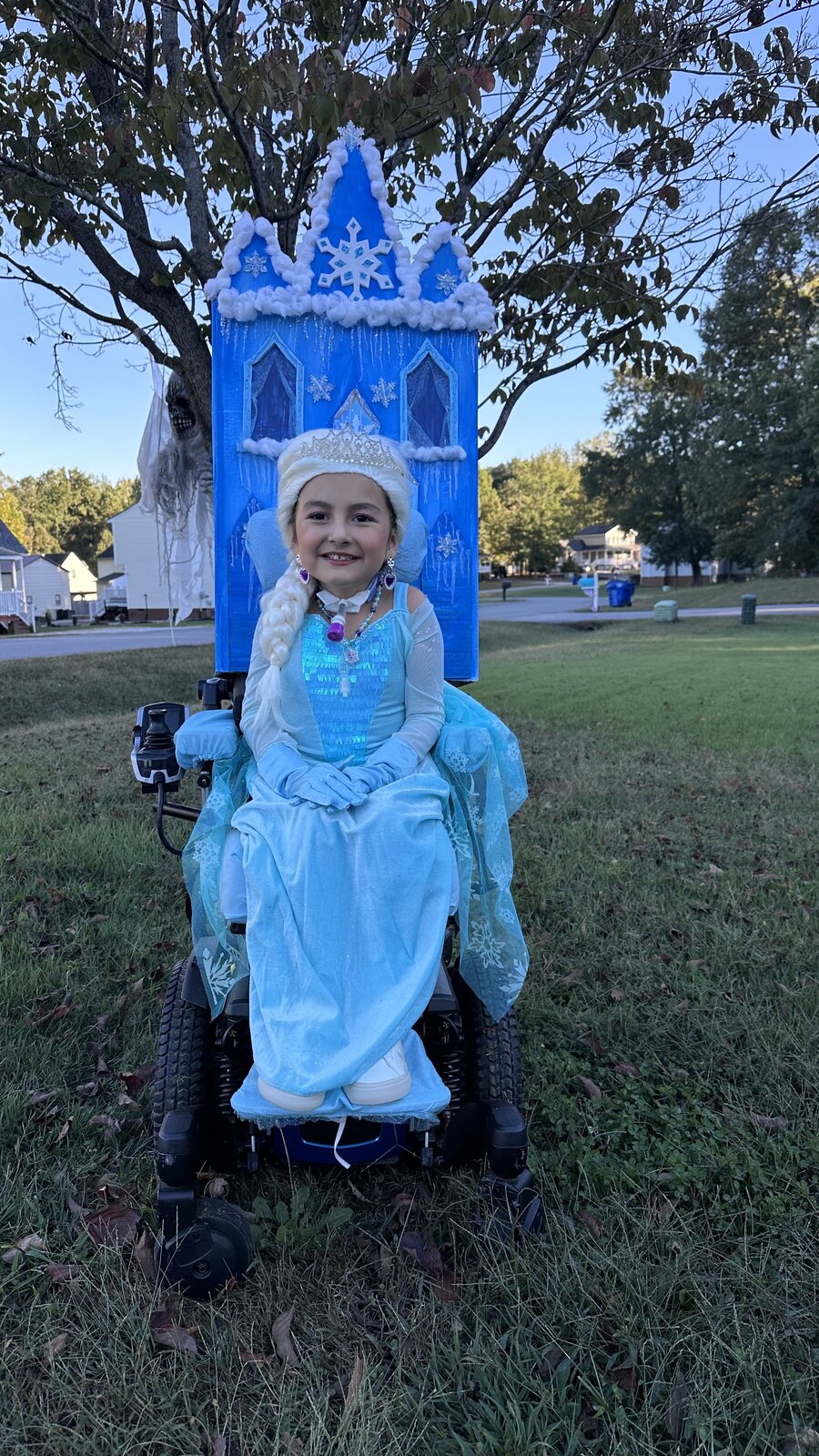 Child in an Elsa costume on wheels