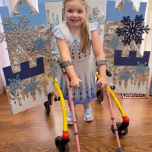 Child in an Elsa costume on wheels