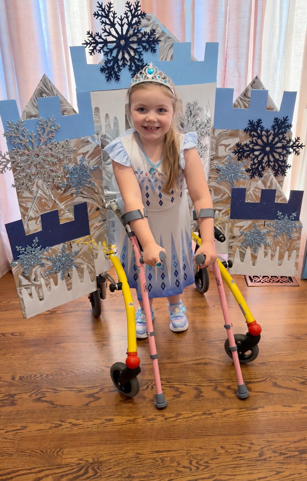 Child in an Elsa costume on wheels