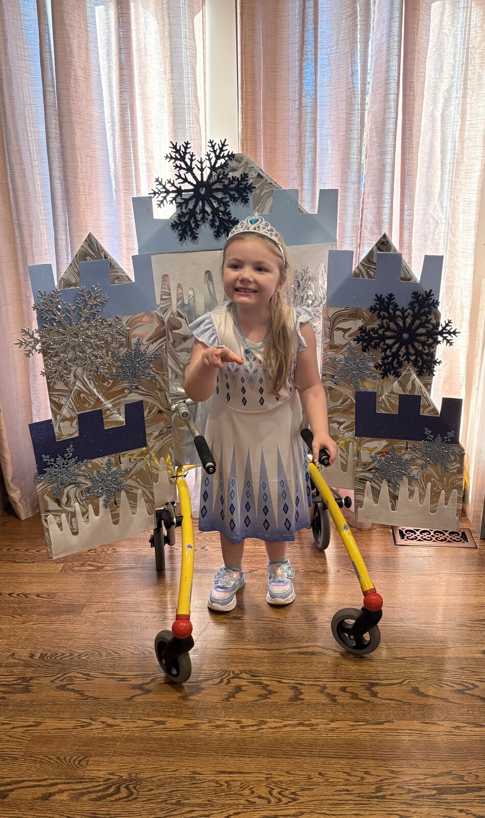 Child in an Elsa costume on wheels