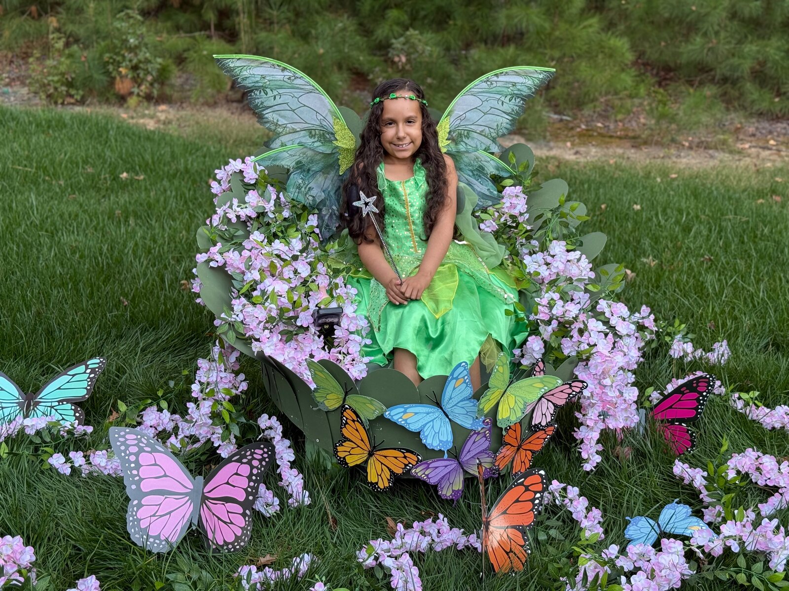 Child in a Fairy in a Leaf costume on wheels