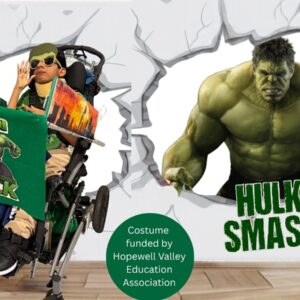 Child in an Incredible Hulk costume on wheels