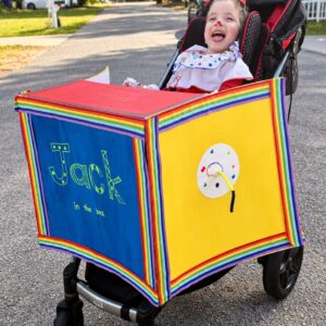 Child in a Jack in the Box costume on wheels