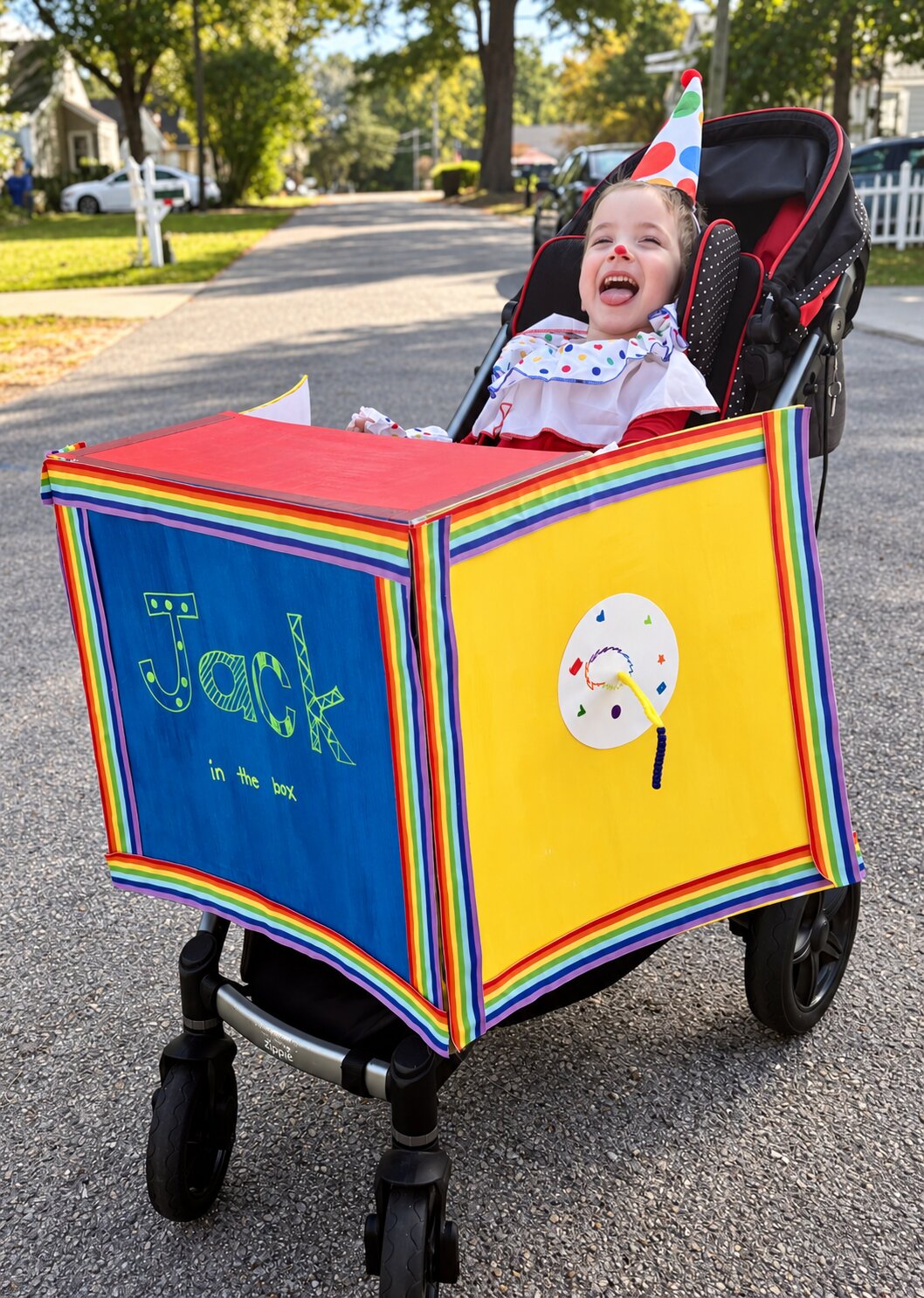 Child in a Jack in the Box costume on wheels