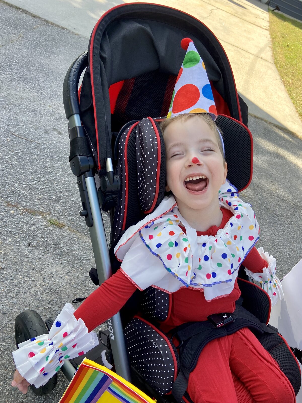 Child in a Jack in the Box costume on wheels