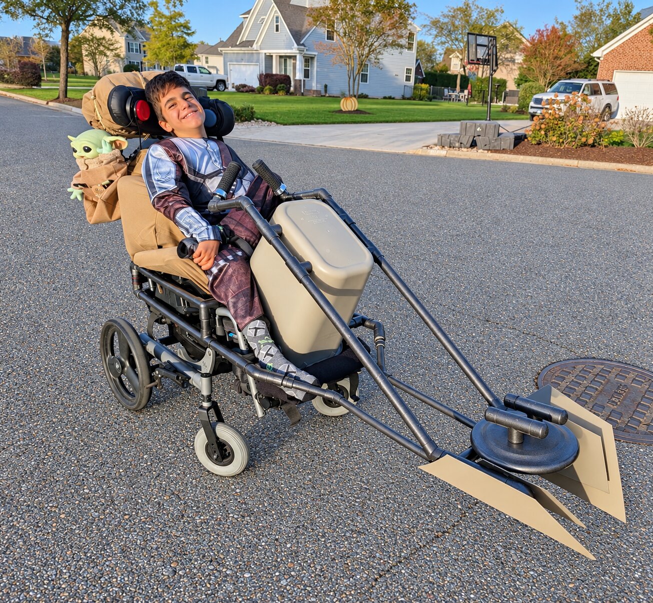 Child in a Mandalorian and Grogu costume on wheels