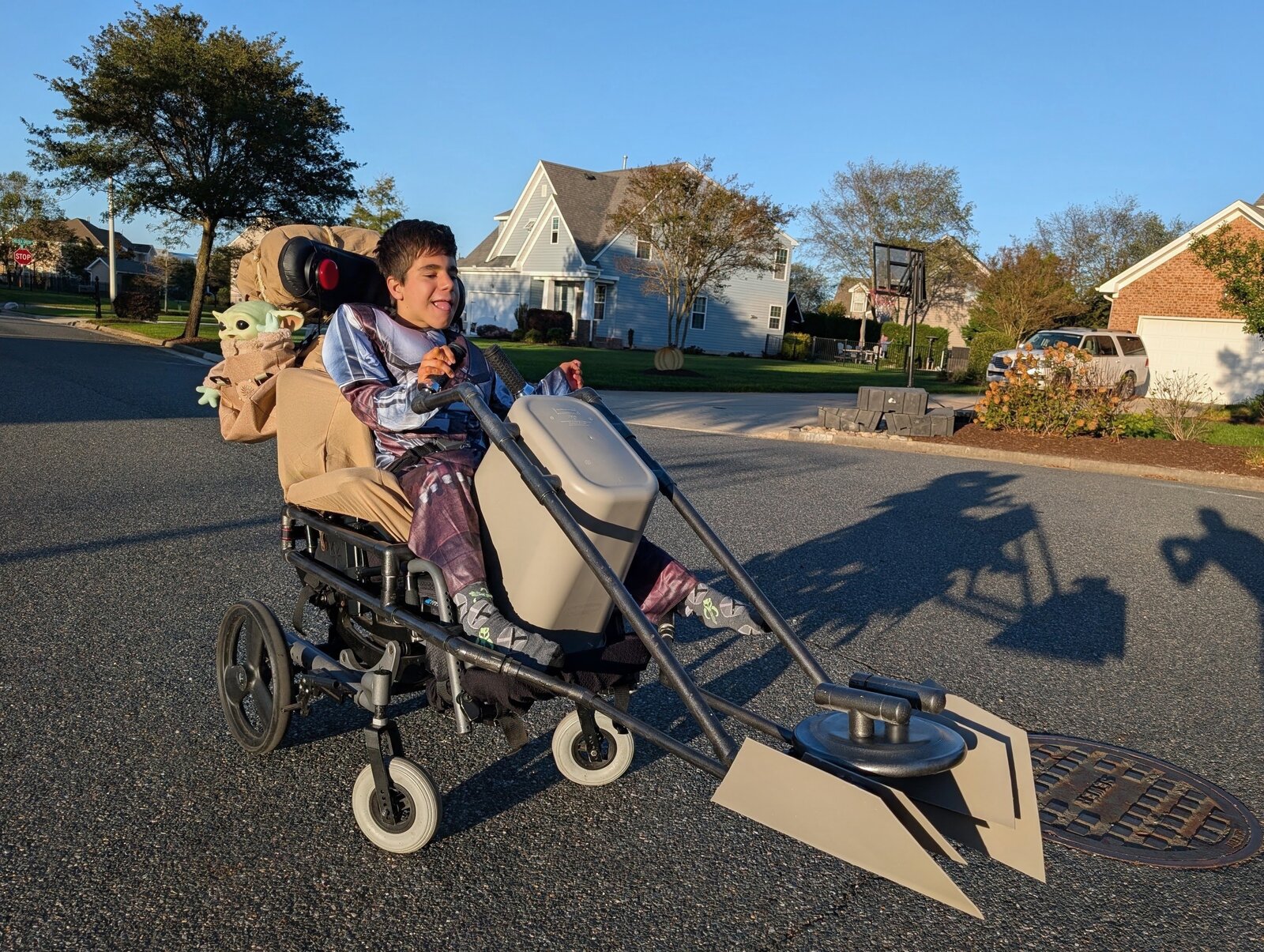 Child in a Mandalorian and Grogu costume on wheels