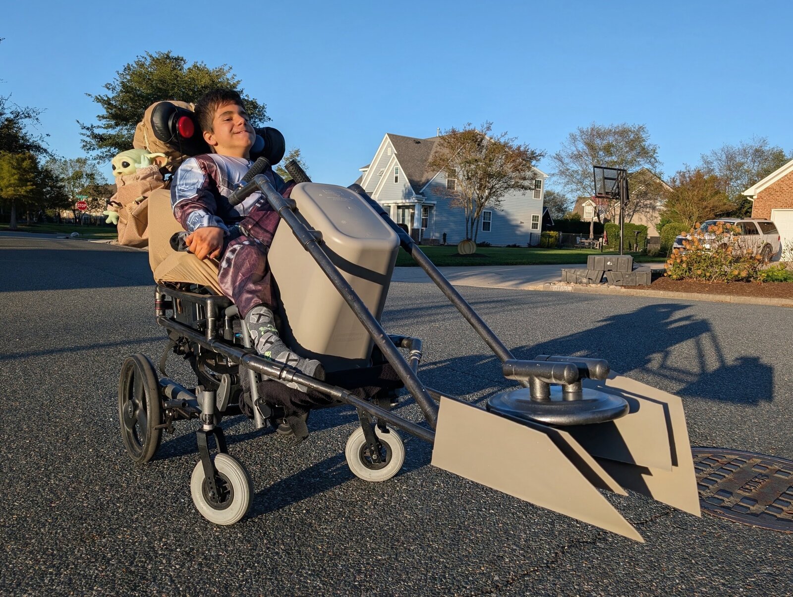 Child in a Mandalorian and Grogu costume on wheels