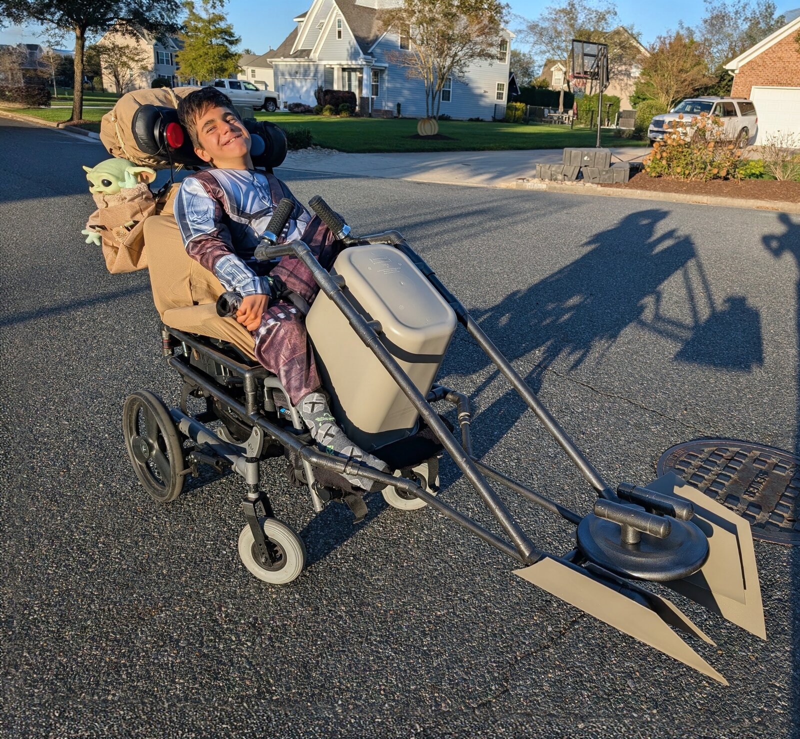Child in a Mandalorian and Grogu costume on wheels