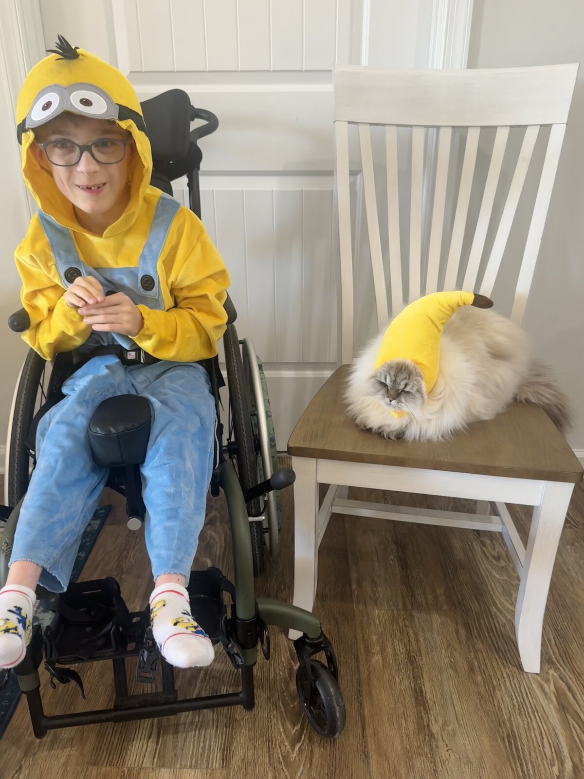 Child in a Minion costume with his favorite food, a banana, on wheels