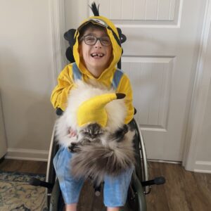 Child in a Minion costume with his favorite food, a banana, on wheels