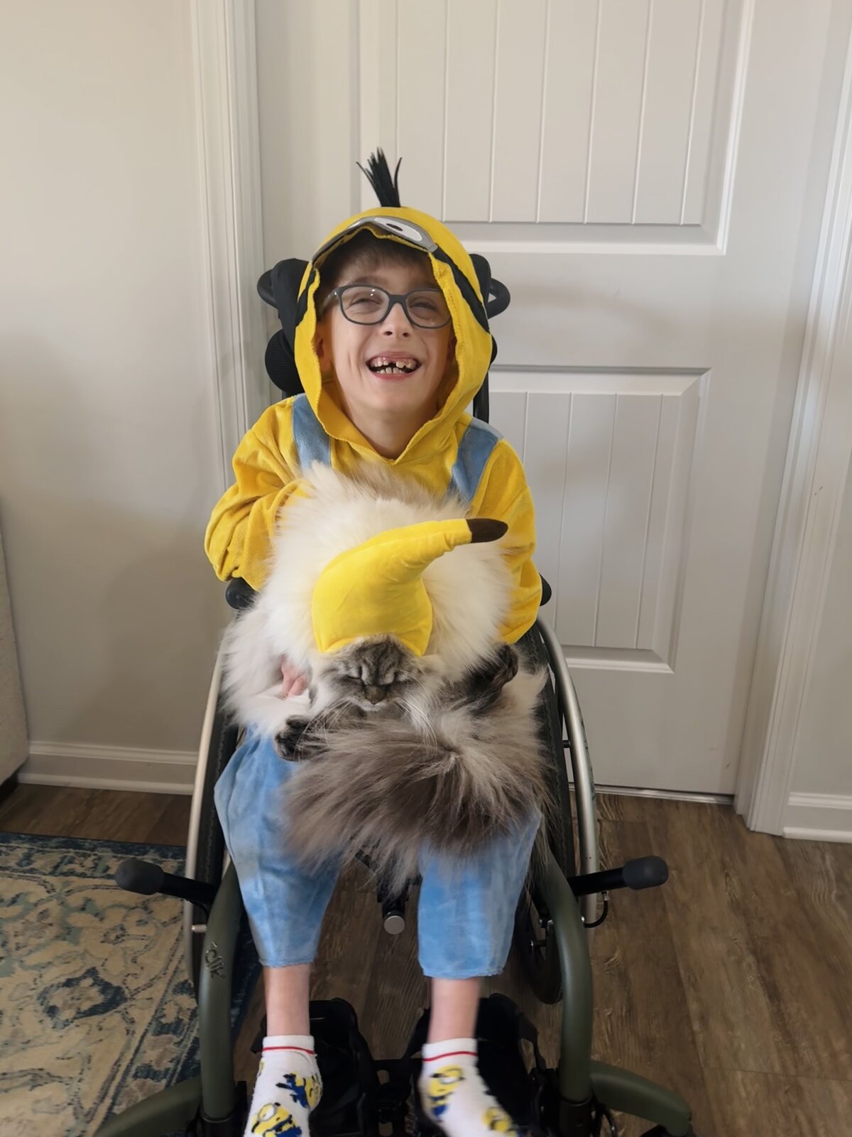 Child in a Minion costume with his favorite food, a banana, on wheels