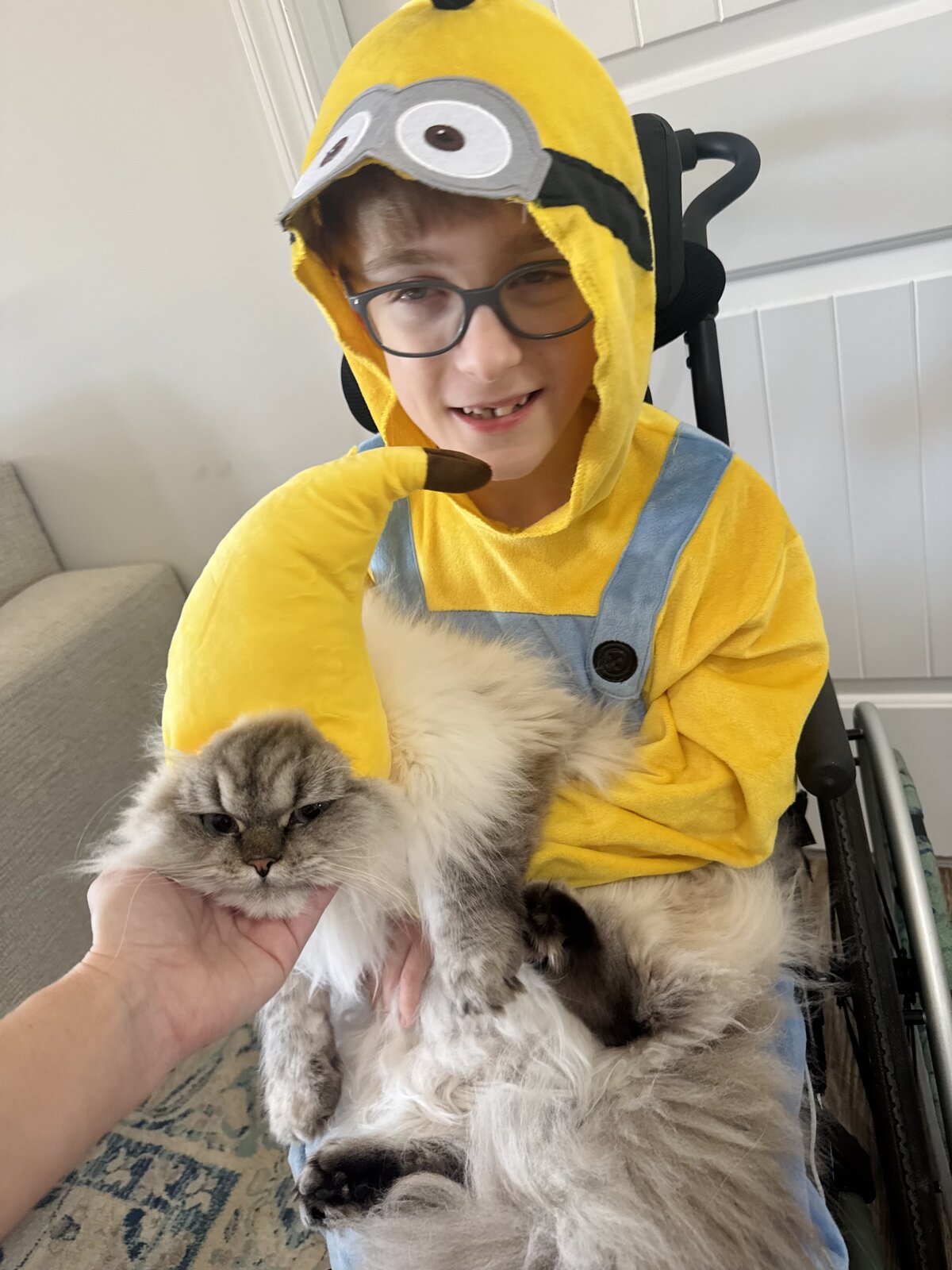 Child in a Minion costume with his favorite food, a banana, on wheels