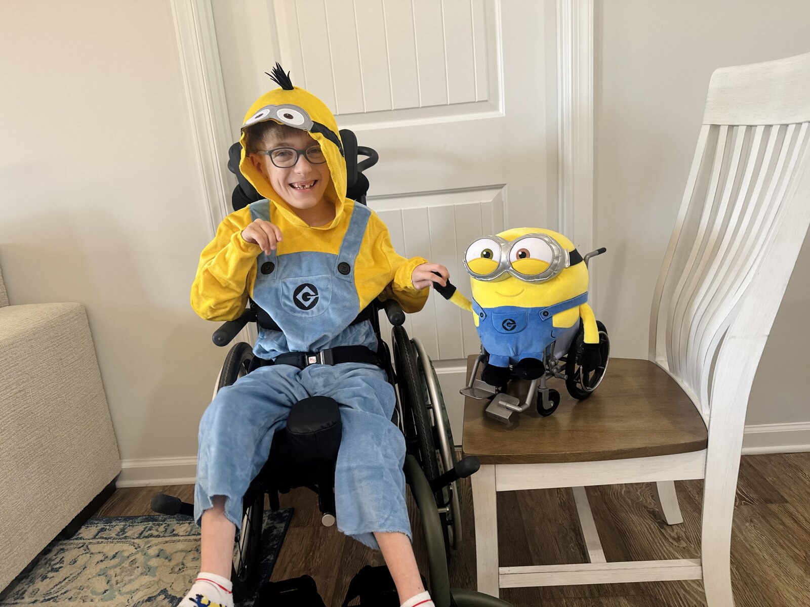 Child in a Minion costume with his favorite food, a banana, on wheels