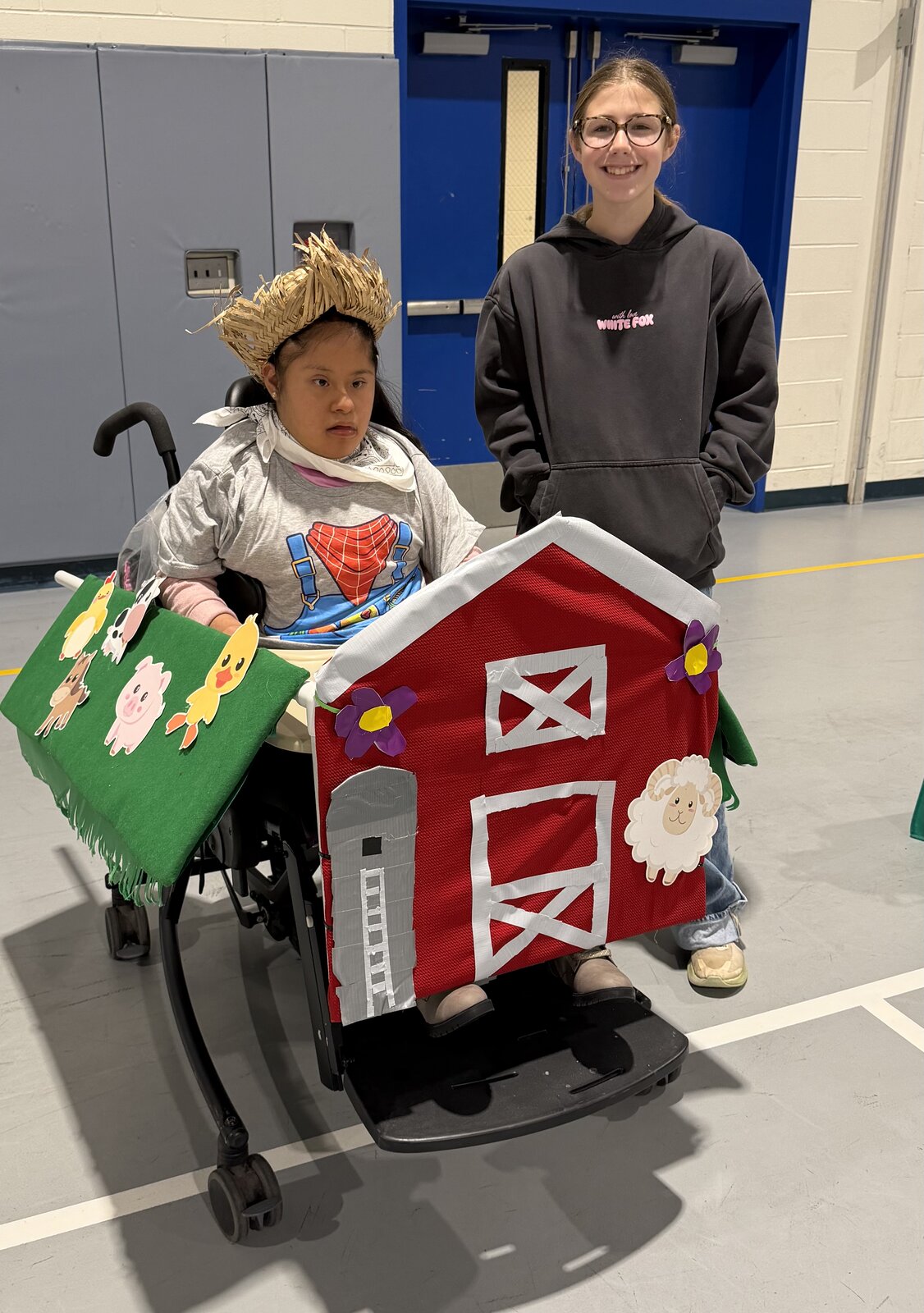Child in an Old MacDonald costume on wheels with the Timberlane Middle School students who built it