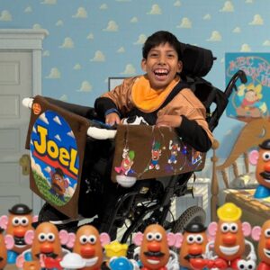Child in a Mr. Potato Head costume on wheels