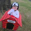 Child in a Snoopy costume on wheels