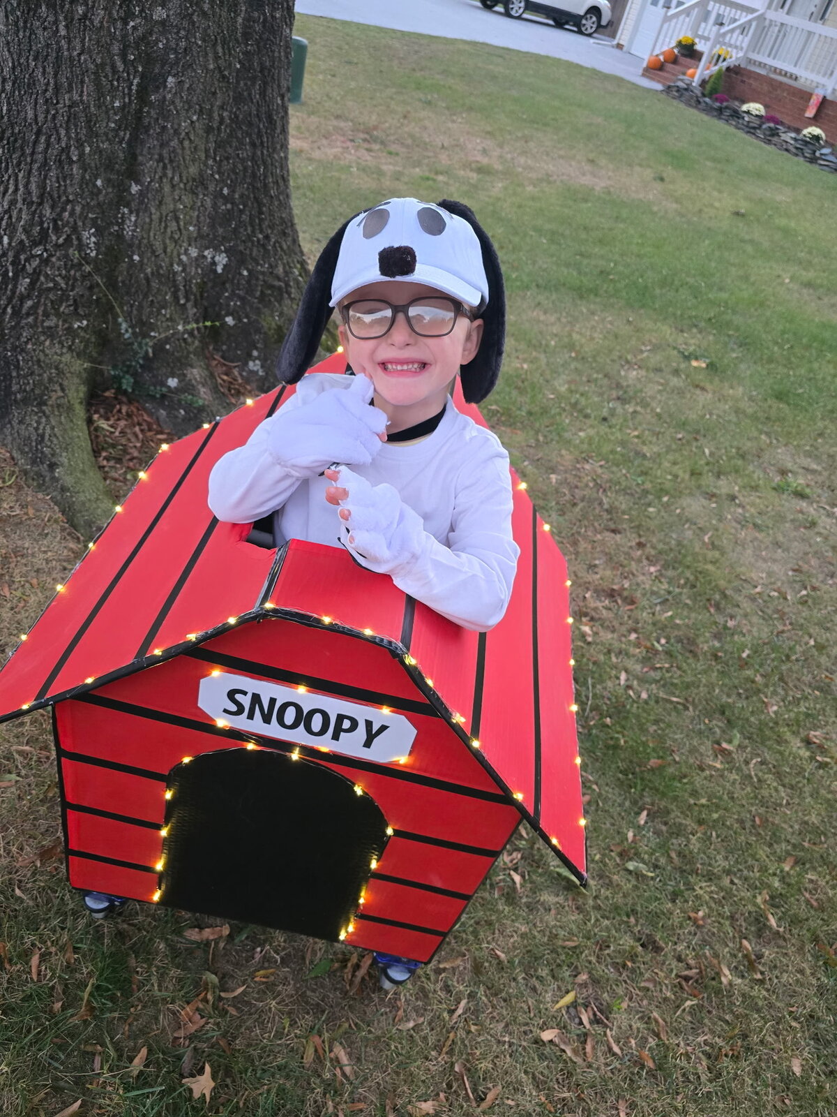 Child in a Snoopy costume on wheels
