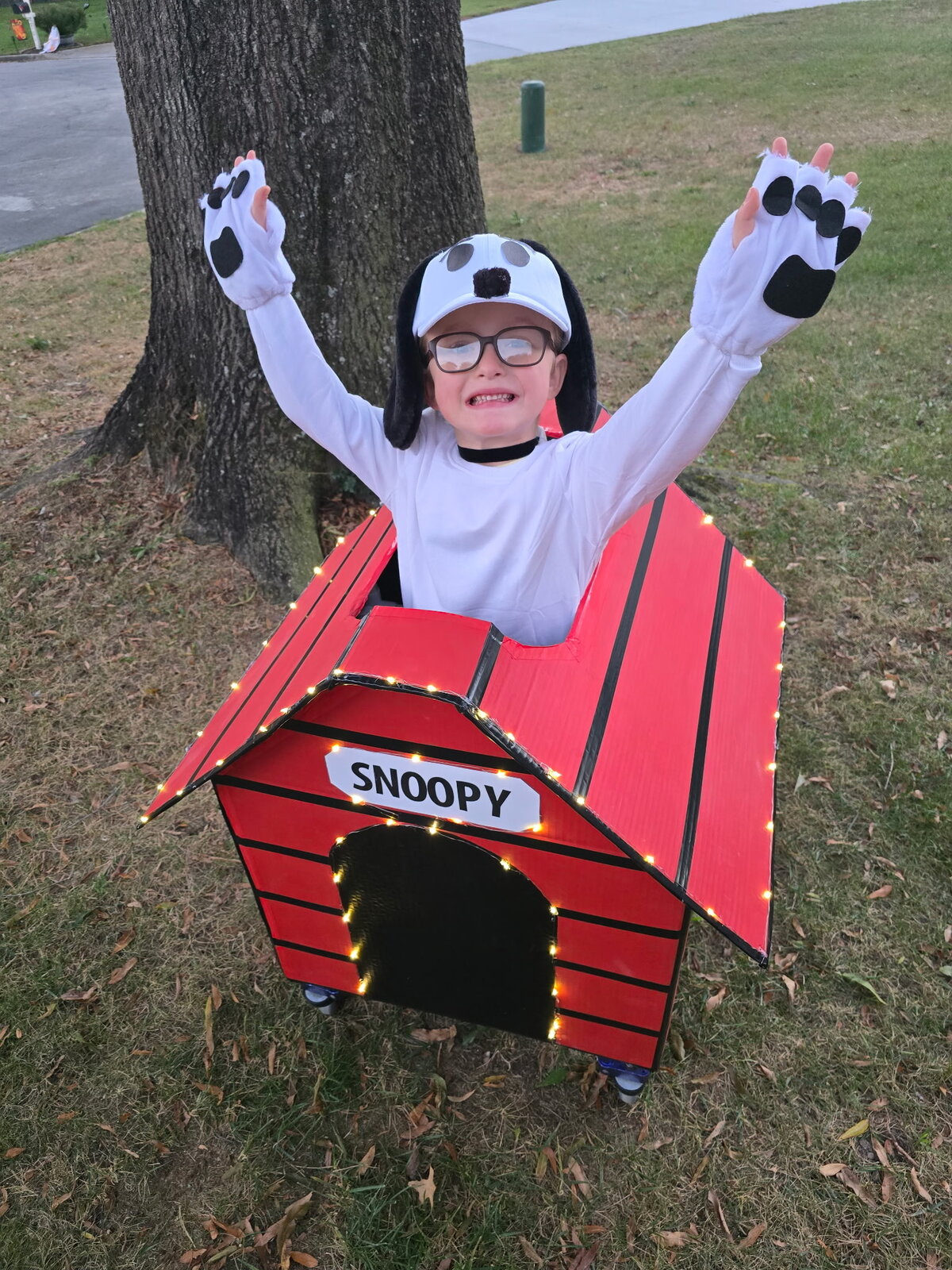 Child in a Snoopy costume on wheels